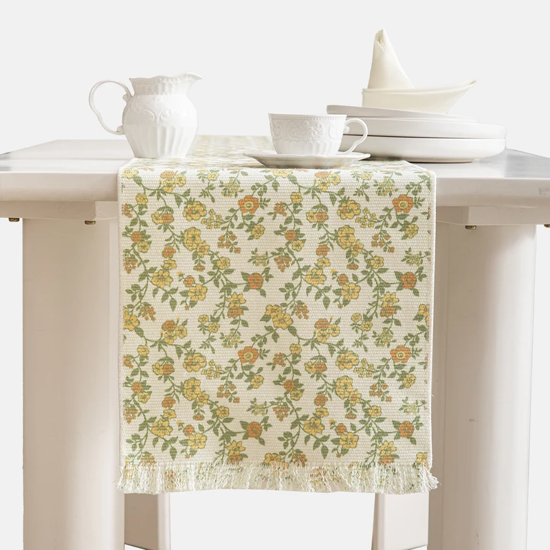 Jacquard table runner with floral vine structure and decorative fringes Stornfield