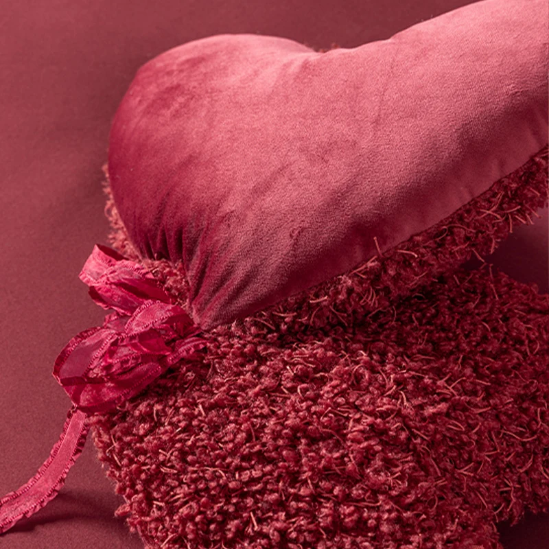 Heart-shaped decorative cushion set made of plush with ribbon and textured teddy surface Stornfield