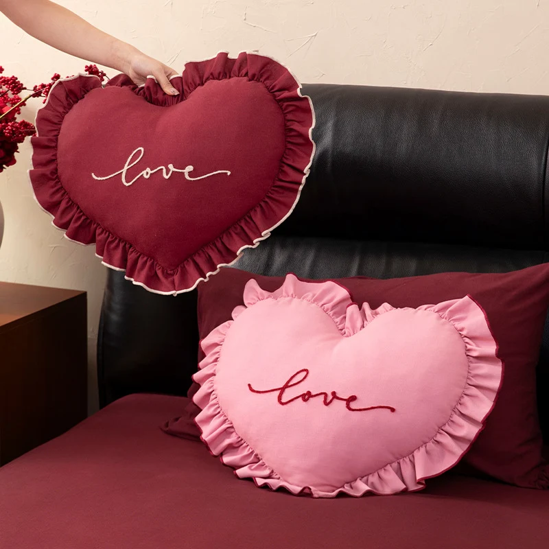Heart-shaped decorative cushion with ruffles and embroidered text Stornfield