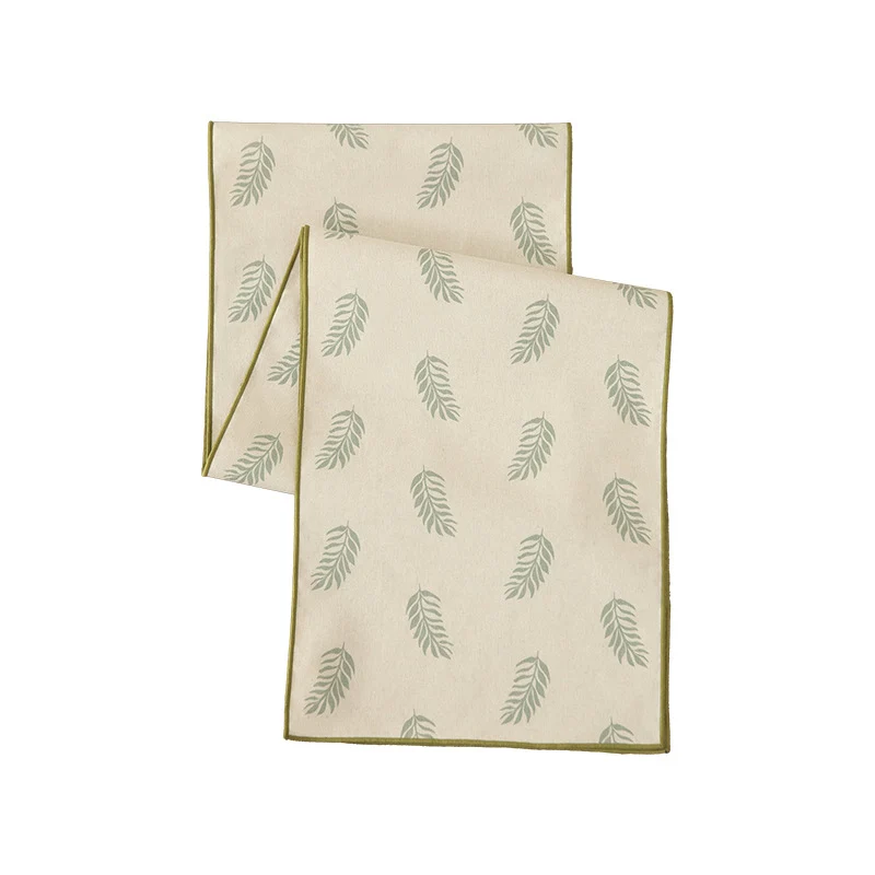 Woven table runner in botanical leaf pattern made of cotton blend Stornfield