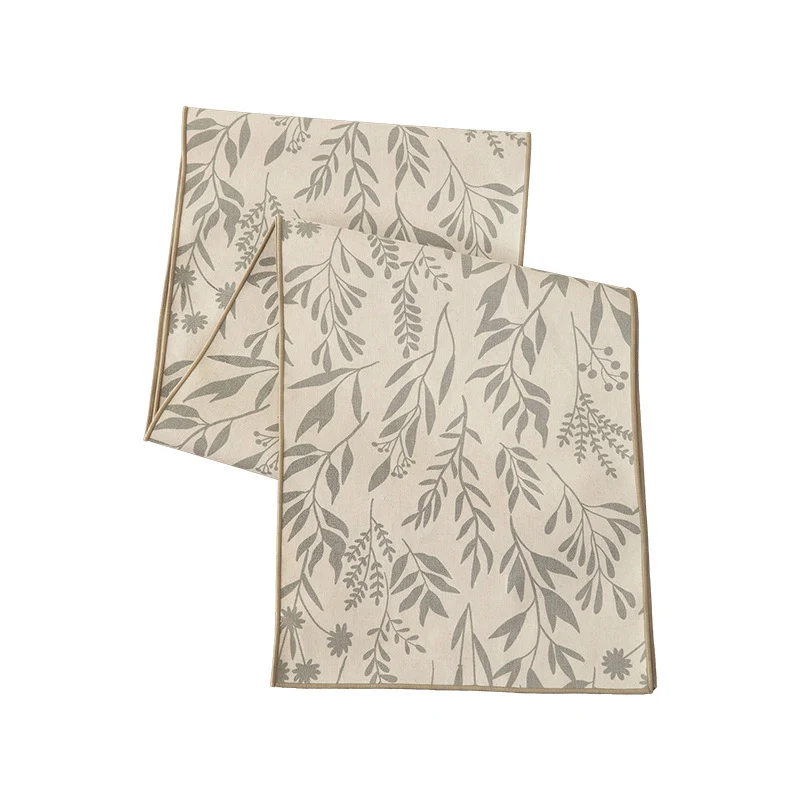 Woven table runner in botanical leaf pattern made of cotton blend Stornfield