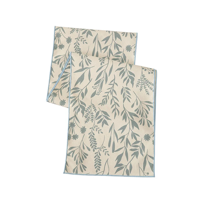 Woven table runner in botanical leaf pattern made of cotton blend Stornfield