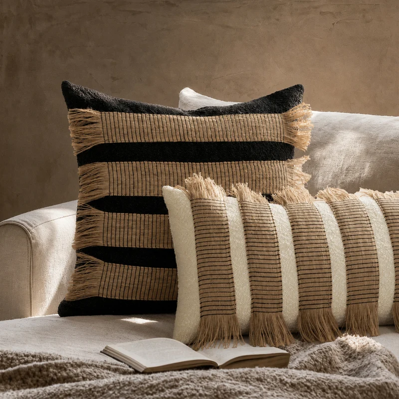 Woven cushion cover with bouclé surface and jute fringes Stornfield