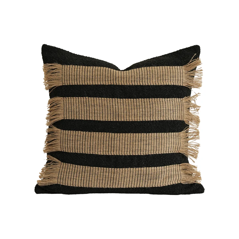 Woven cushion cover with bouclé surface and jute fringes Stornfield