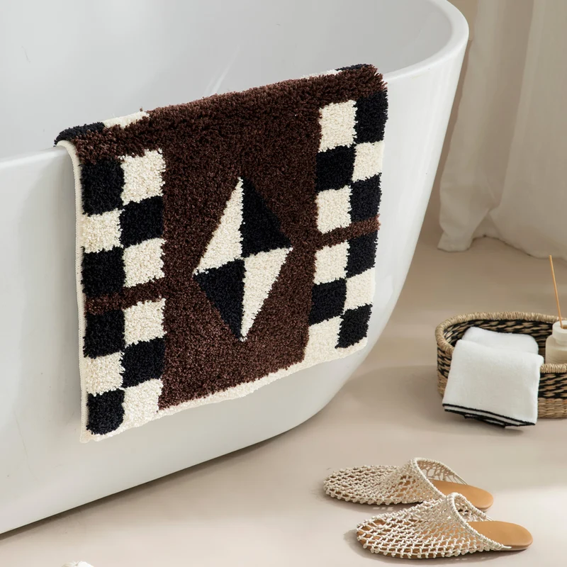 Tufted, soft bath mat with geometric ethnic pattern and non-slip underside Stornfield