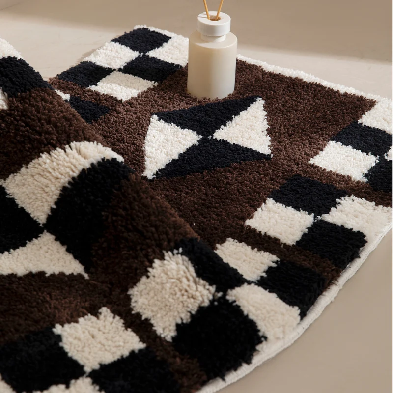 Tufted, soft bath mat with geometric ethnic pattern and non-slip underside Stornfield