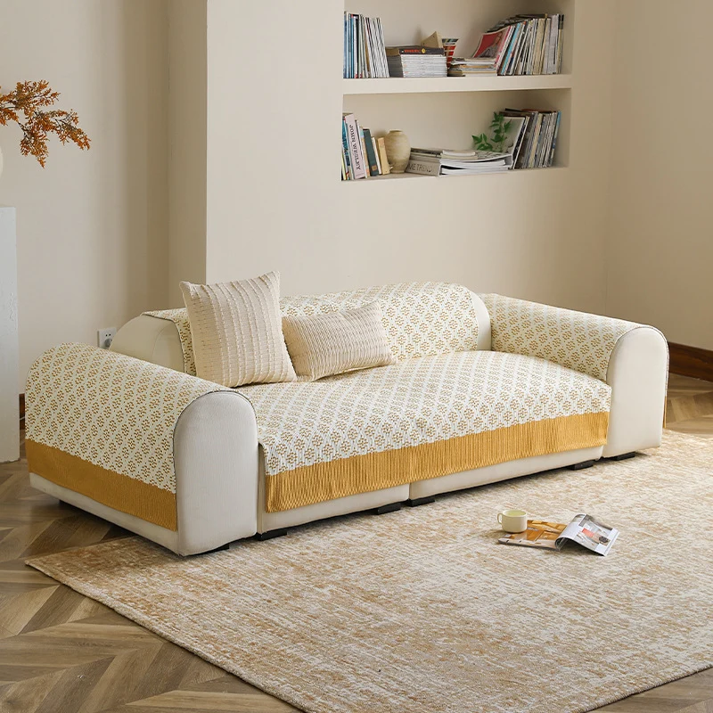 Knitted sofa cover with jacquard pattern and reinforced hem border Stornfield