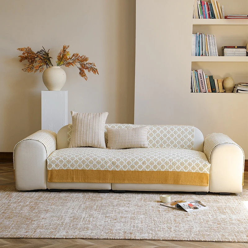 Knitted sofa cover with jacquard pattern and reinforced hem border Stornfield