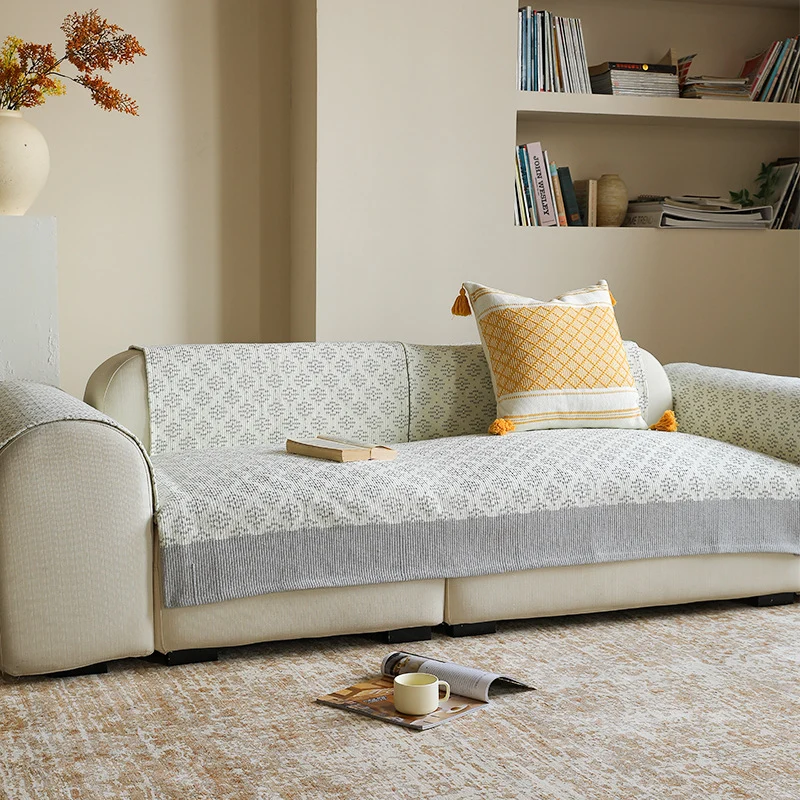 Knitted sofa cover with jacquard pattern and reinforced hem border Stornfield
