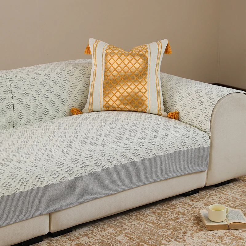 Knitted sofa cover with jacquard pattern and reinforced hem border Stornfield