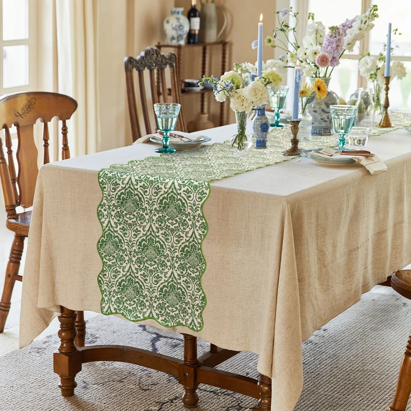 Damask-style table runner with curved wave edge and fine ornamental print Stornfield