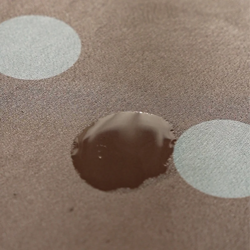 Wipeable placemat made of PVC with large polka dot pattern and non-slip backing Stornfield