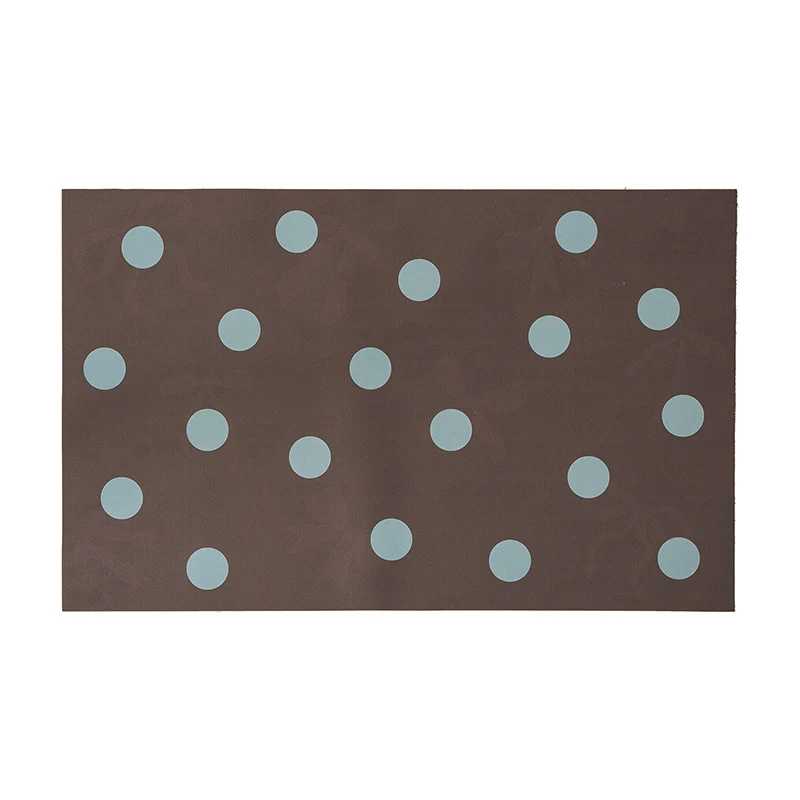 Wipeable placemat made of PVC with large polka dot pattern and non-slip backing Stornfield