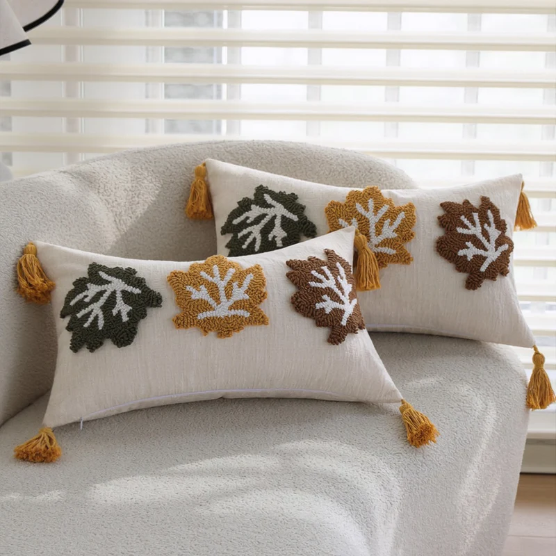 Rectangular decorative cushion cover made of linen look with raised leaf appliqués and corner tassels Stornfield
