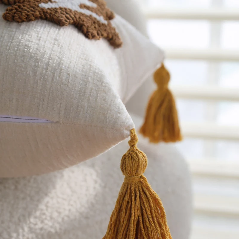 Rectangular decorative cushion cover made of linen look with raised leaf appliqués and corner tassels Stornfield