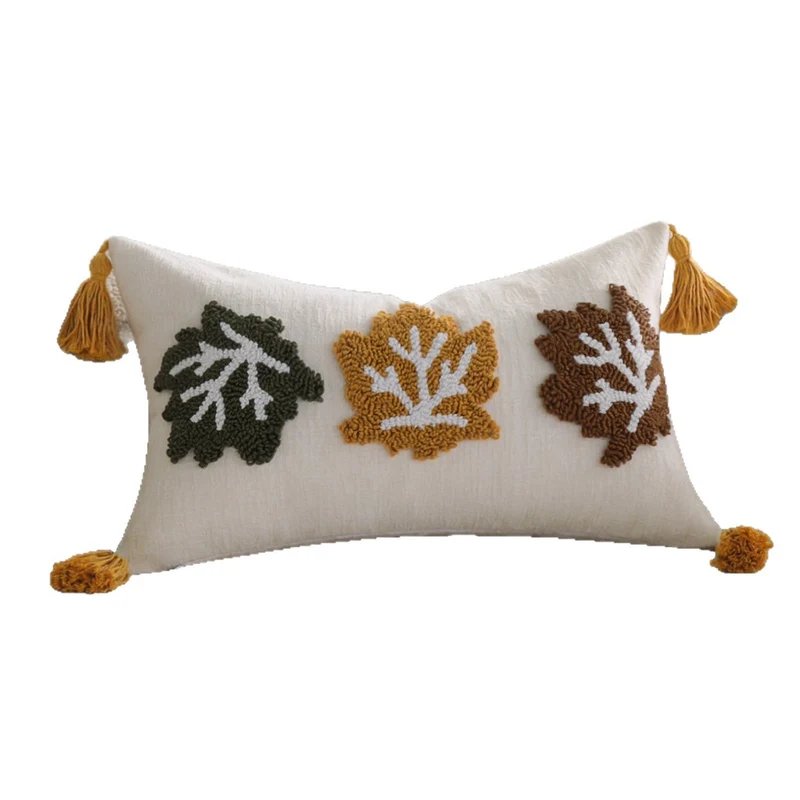 Rectangular decorative cushion cover made of linen look with raised leaf appliqués and corner tassels Stornfield