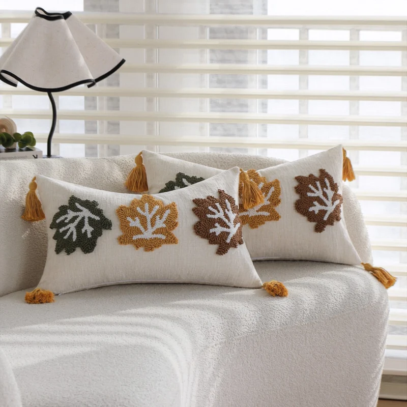 Rectangular decorative cushion cover made of linen look with raised leaf appliqués and corner tassels Stornfield
