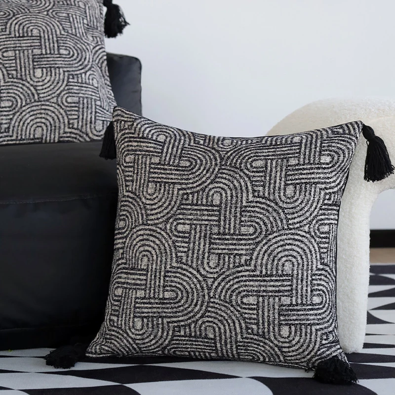 Square cushion cover made of textured bouclé weaving with geometric relief and corner tassels Stornfield