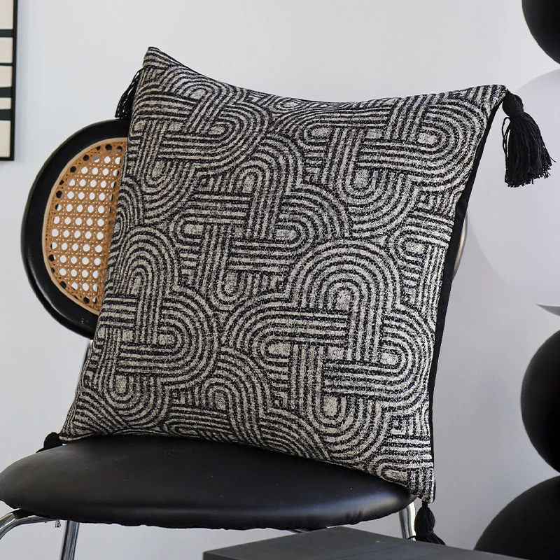 Square cushion cover made of textured bouclé weaving with geometric relief and corner tassels Stornfield