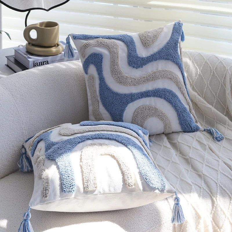 Square cushion cover with relief hand-tufted wave structure made of cotton-linen blend and decorative corner tassels Stornfield