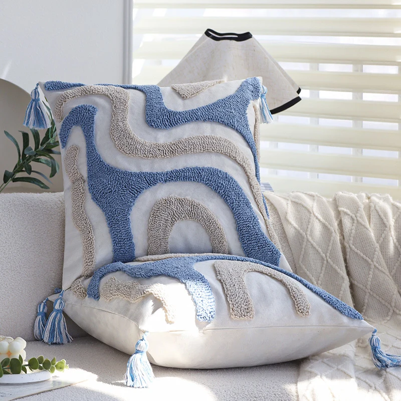 Square cushion cover with relief hand-tufted wave structure made of cotton-linen blend and decorative corner tassels Stornfield