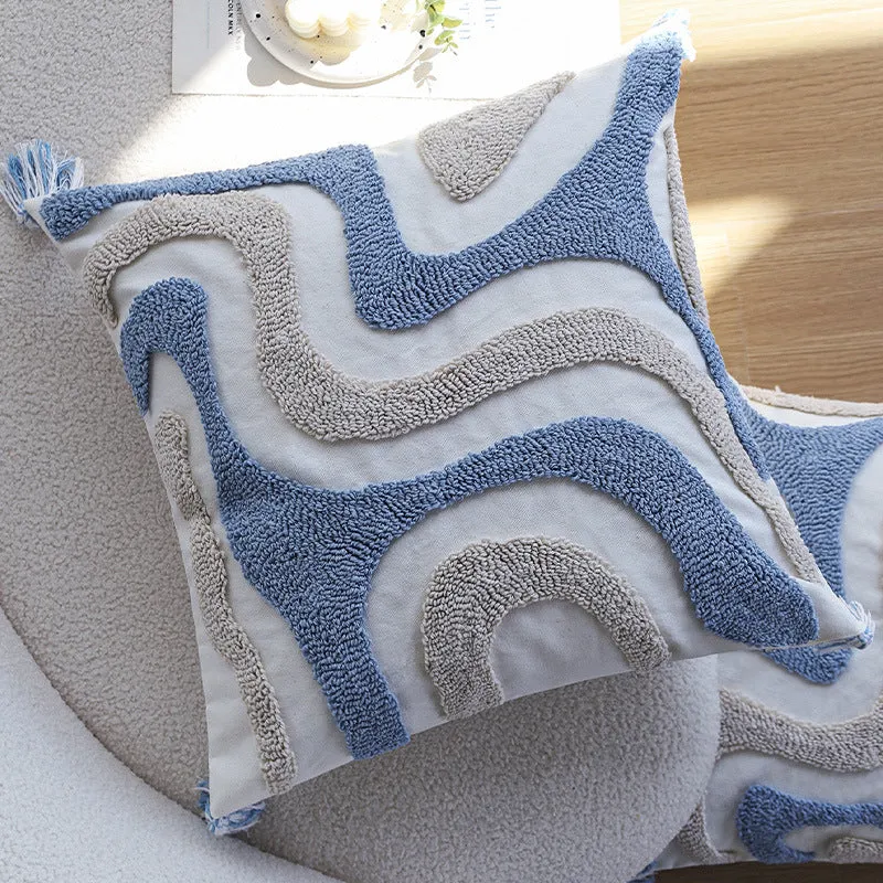 Square cushion cover with relief hand-tufted wave structure made of cotton-linen blend and decorative corner tassels Stornfield