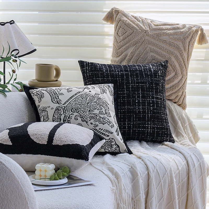 Square decorative cushion cover with hand-tufted geometric relief and corner tassels Stornfield