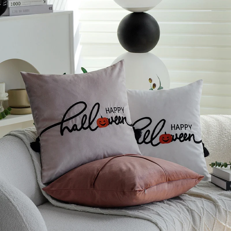 Square decorative cushion cover with embroidered Happy Halloween lettering, pumpkin appliqué, and tassels Stornfield