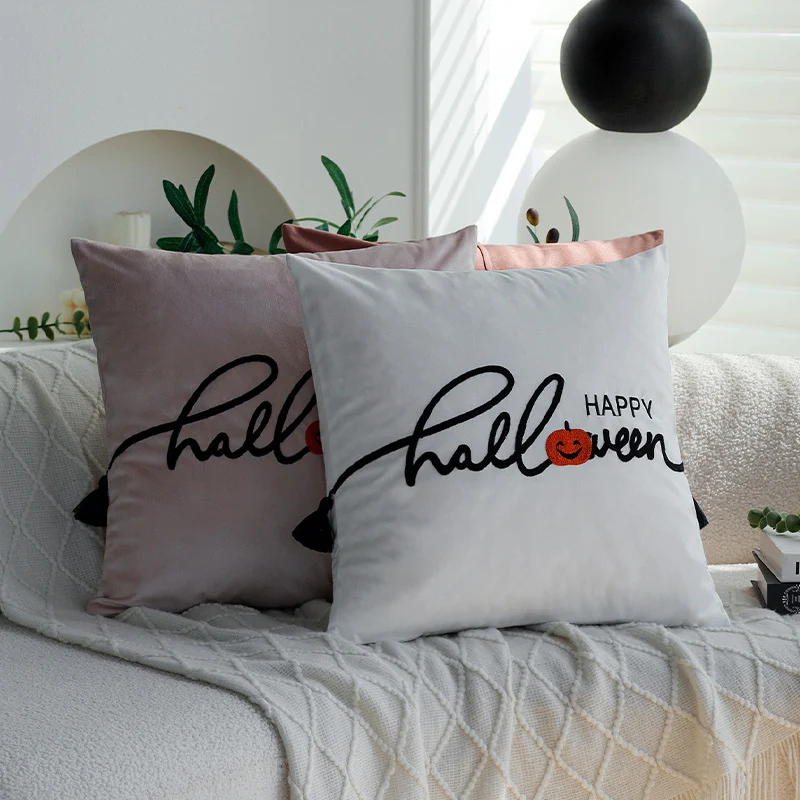 Square decorative cushion cover with embroidered Happy Halloween lettering, pumpkin appliqué, and tassels Stornfield