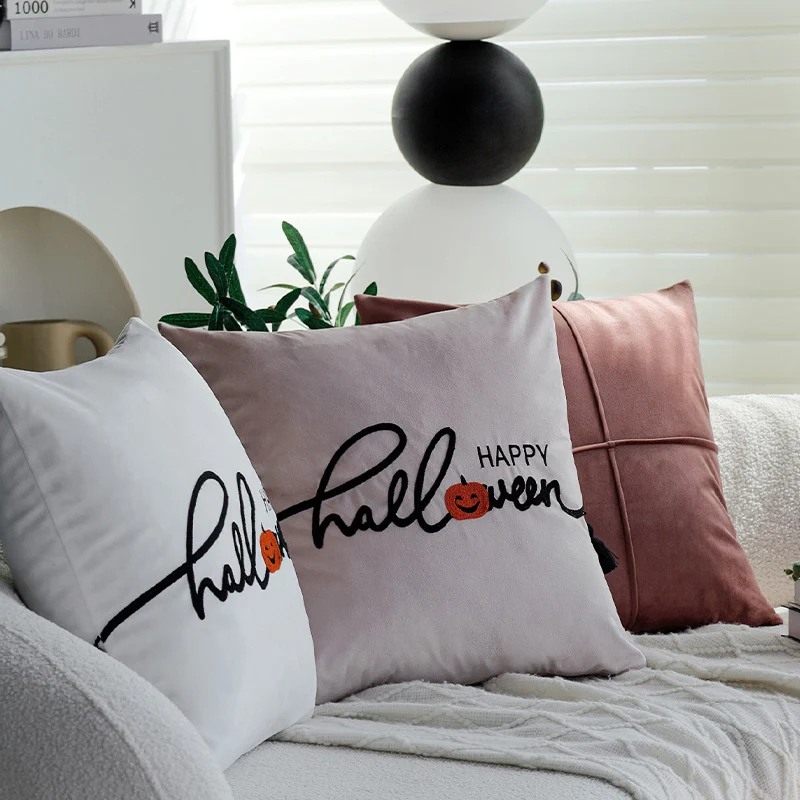 Square decorative cushion cover with embroidered Happy Halloween lettering, pumpkin appliqué, and tassels Stornfield