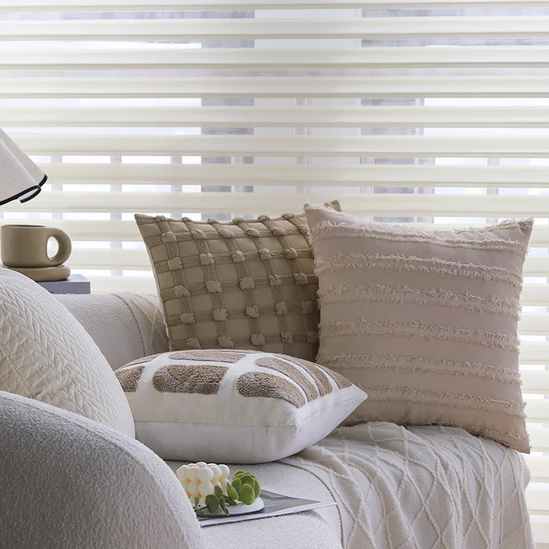 Decorative cushion cover with knotted grid structure and fine woven applications Stornfield