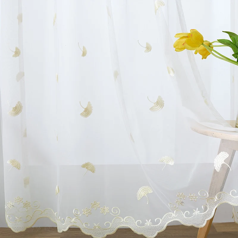 Transparent curtain drape made of fine tulle with embroidered ginkgo leaves and curved lace finish Stornfield