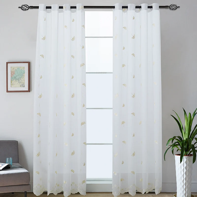 Transparent curtain drape made of fine tulle with embroidered ginkgo leaves and curved lace finish Stornfield