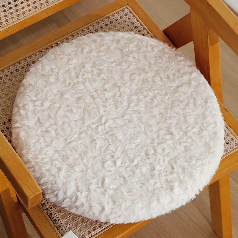 Round seat cushion made of dense artificial fur with comfortable padding and anti-slip base Stornfield