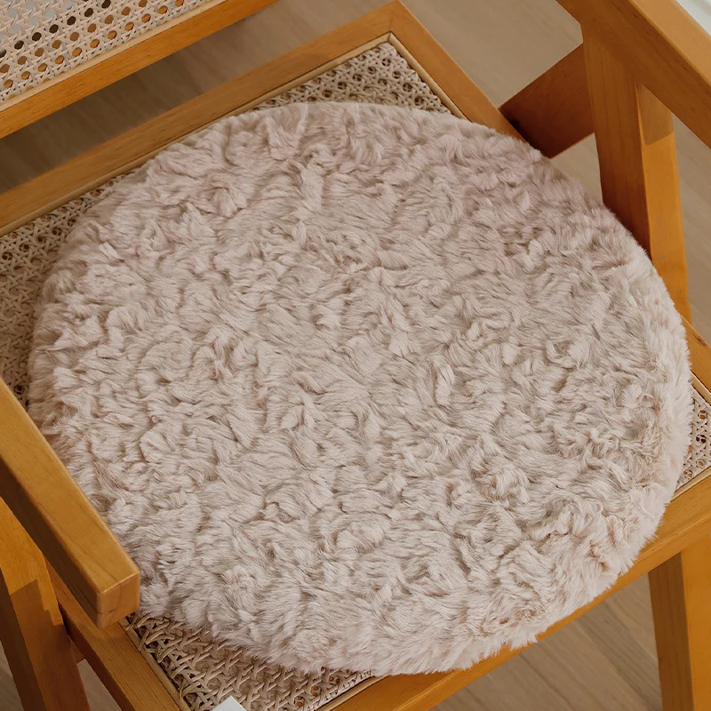 Round seat cushion made of dense artificial fur with comfortable padding and anti-slip base Stornfield