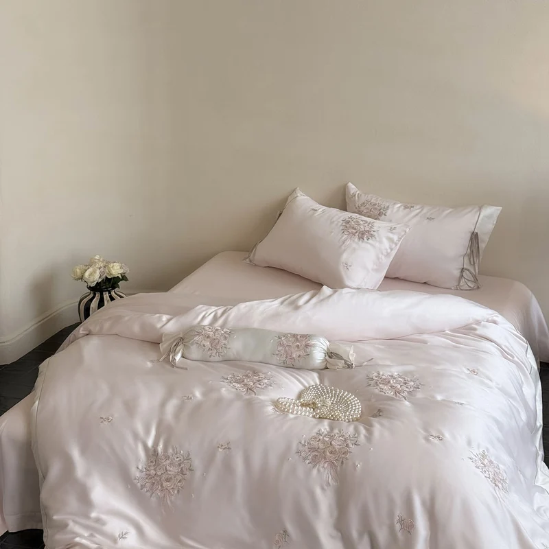 Fine glossy satin bedding set with embroidered rose bouquets and decorative pillow roll Stornfield