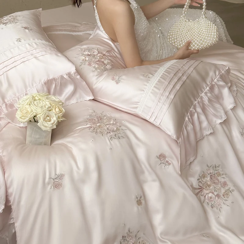 Fine glossy satin bedding set with embroidered rose bouquets and decorative pillow roll Stornfield