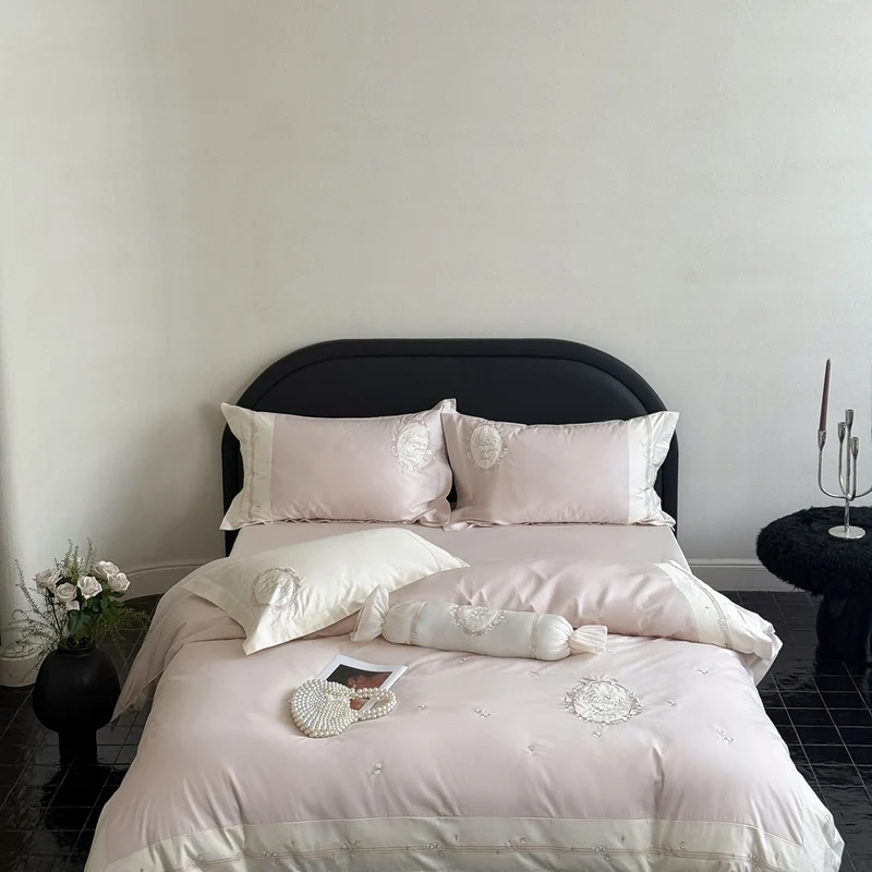 Noble cotton satin bed linen set with delicate rosette embroidery and decorative cushion roll Stornfield