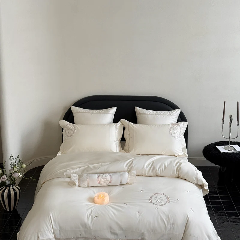 Noble cotton satin bed linen set with delicate rosette embroidery and decorative cushion roll Stornfield