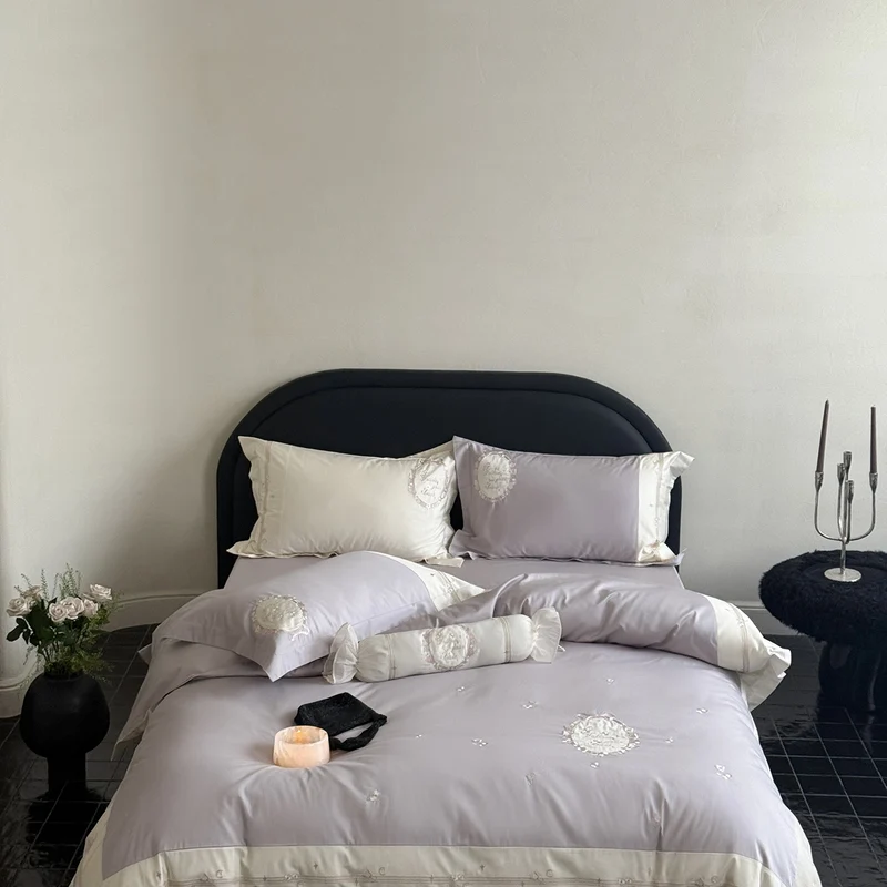Noble cotton satin bed linen set with delicate rosette embroidery and decorative cushion roll Stornfield